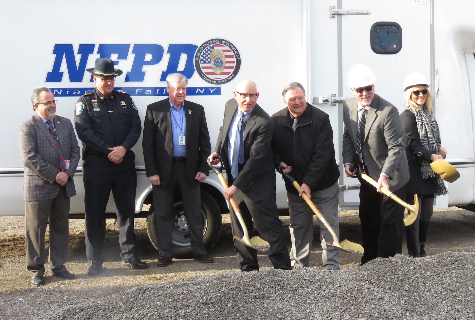 From left, Niagara County Department of Economic Development Commissioner Michael Casale, Niagara County Sheriff James Voutour and Niagara County Legislator David Godfrey watch as New York State Homes and Community Renewal Assistant Commissioner Leonard Skrill, Town of Niagara Supervisor Lee Wallace, Empire Emergency Apparatus President Michael McLaughlin and Kathleen McLaughlin break ground on a new 10,000-square-foot expansion. (Photo by David Yarger)